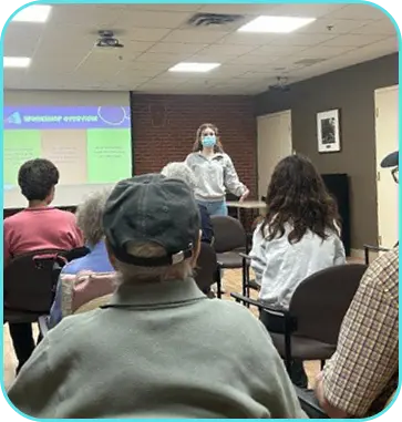 Meeting of people with somebody presenting at the front
